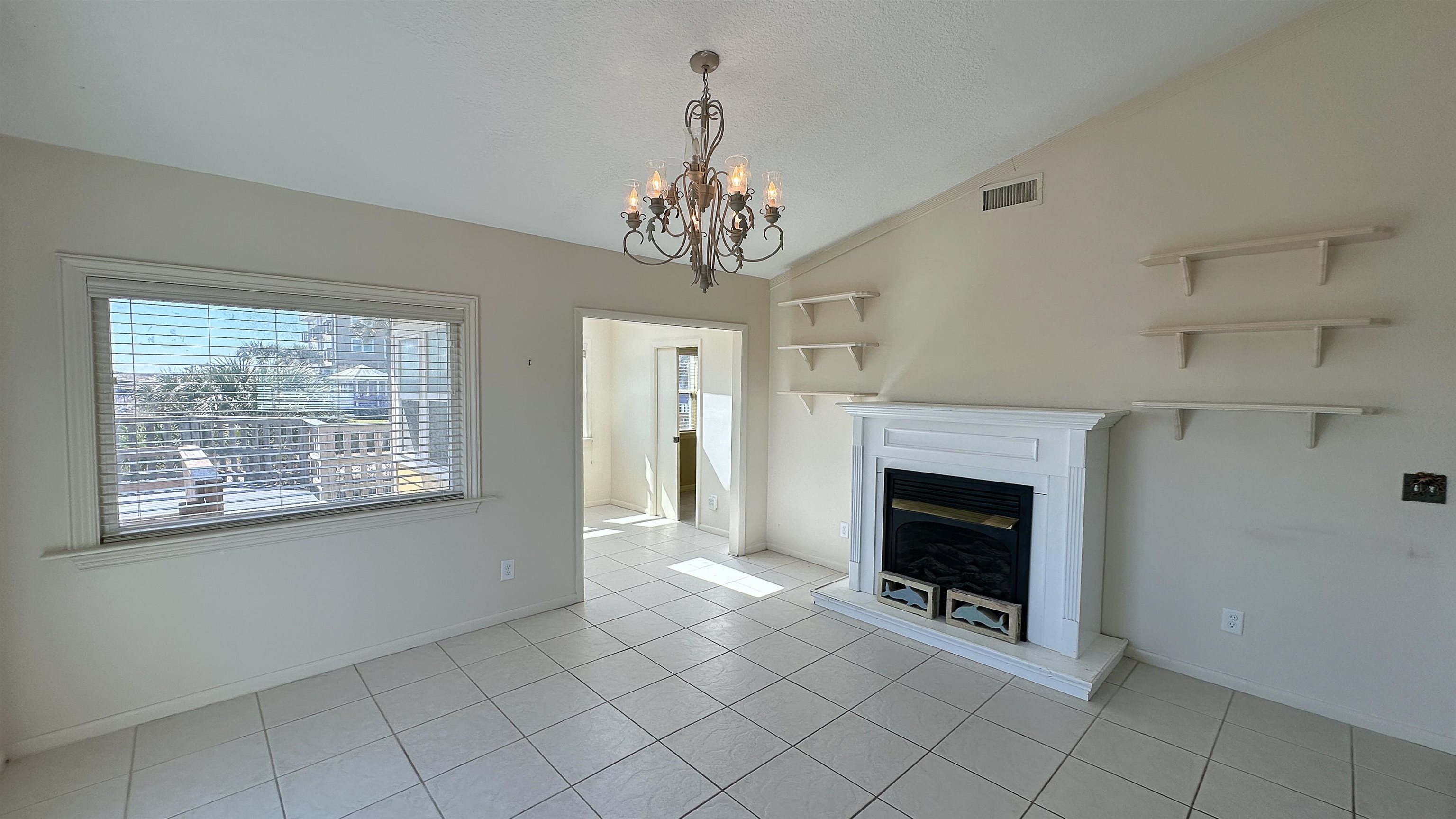 2 11th Street St. Augustine Beach, FL 32080 - Photo 60 of 72 a view of an empty room with a fireplace and a window