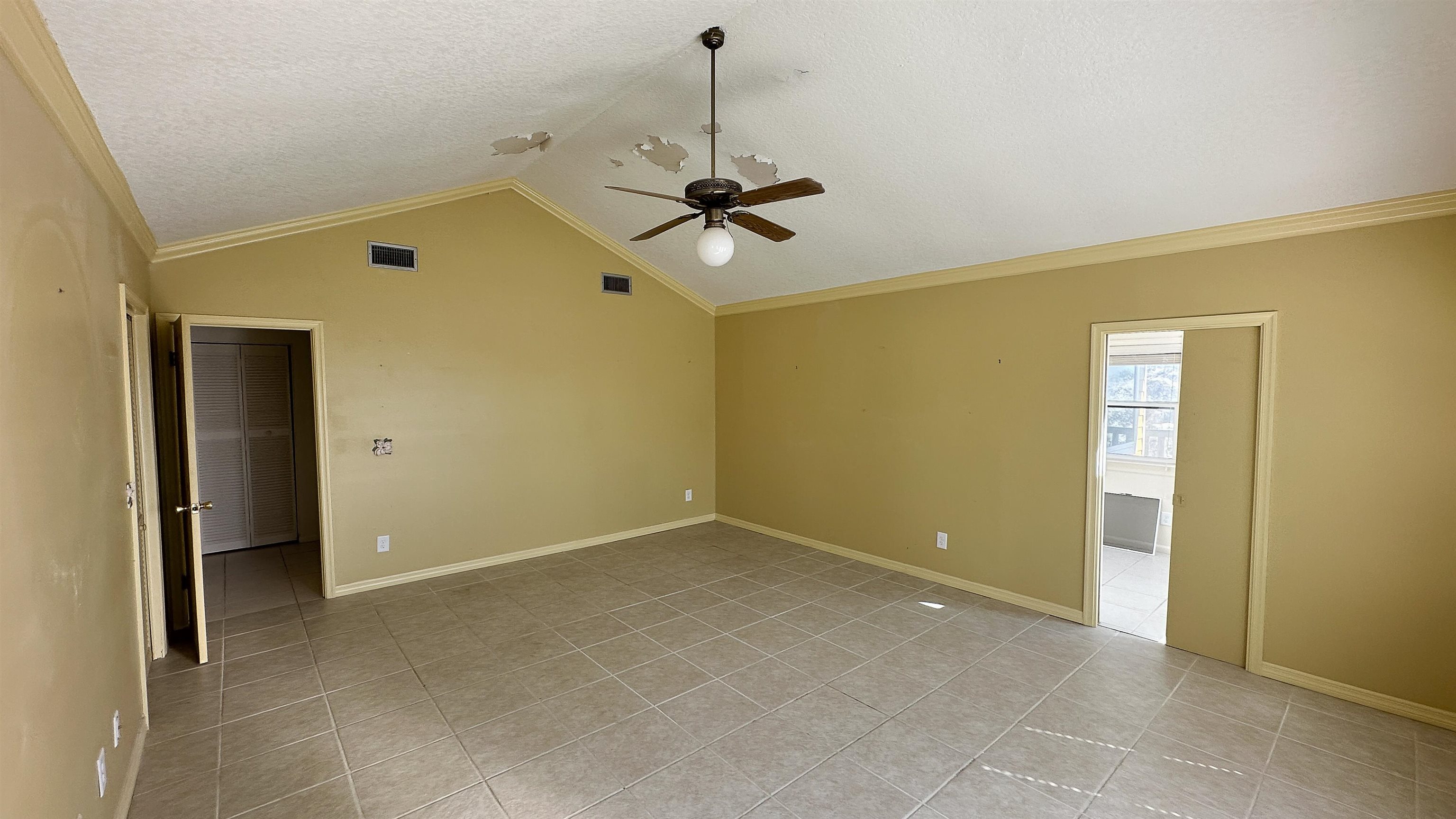 2 11th Street St. Augustine Beach, FL 32080 - Photo 61 of 72 Unfurnished room featuring crown molding, a ceiling fan, a textured ceiling, and light tile patterned floors