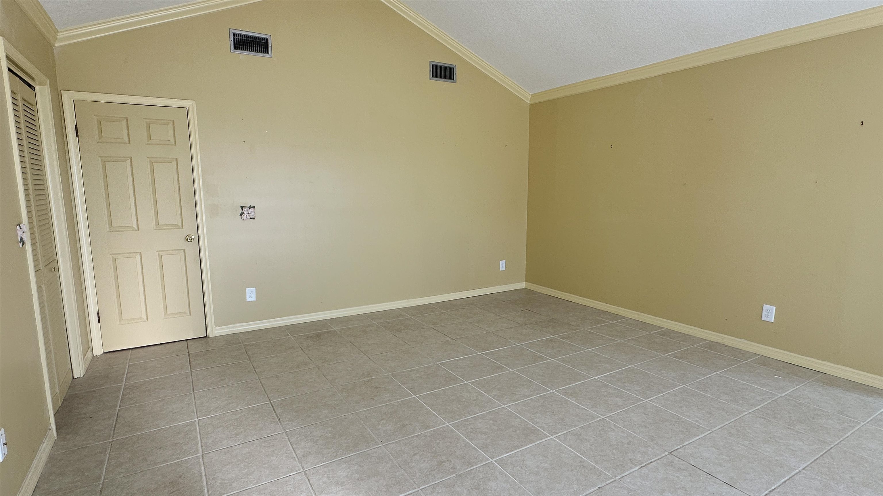 2 11th Street St. Augustine Beach, FL 32080 - Photo 62 of 72 Spare room with crown molding, lofted ceiling, and light tile patterned floors
