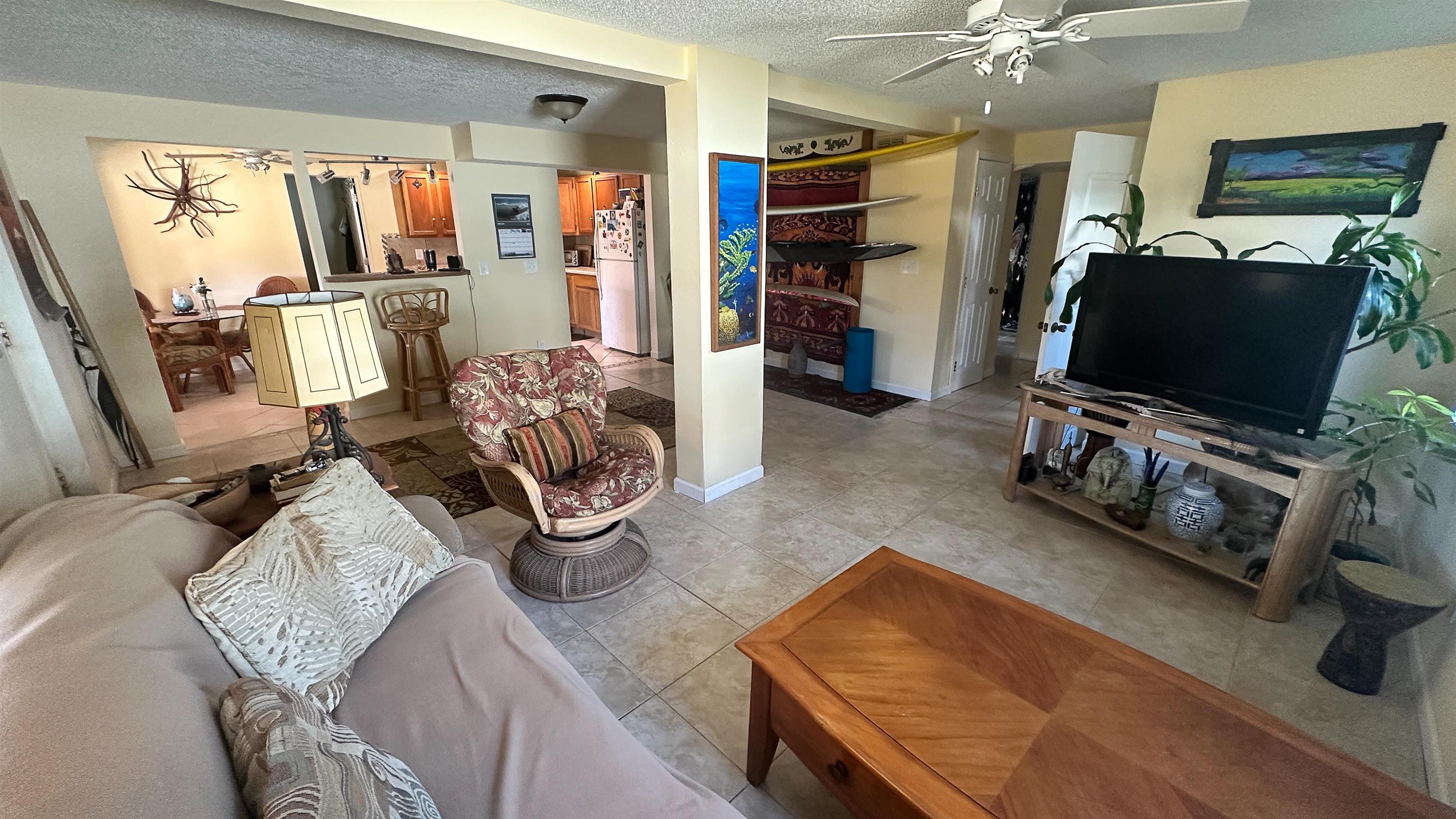 2 11th Street St. Augustine Beach, FL 32080 - Photo 63 of 72 Living room with ceiling fan, a textured ceiling, and light tile patterned flooring