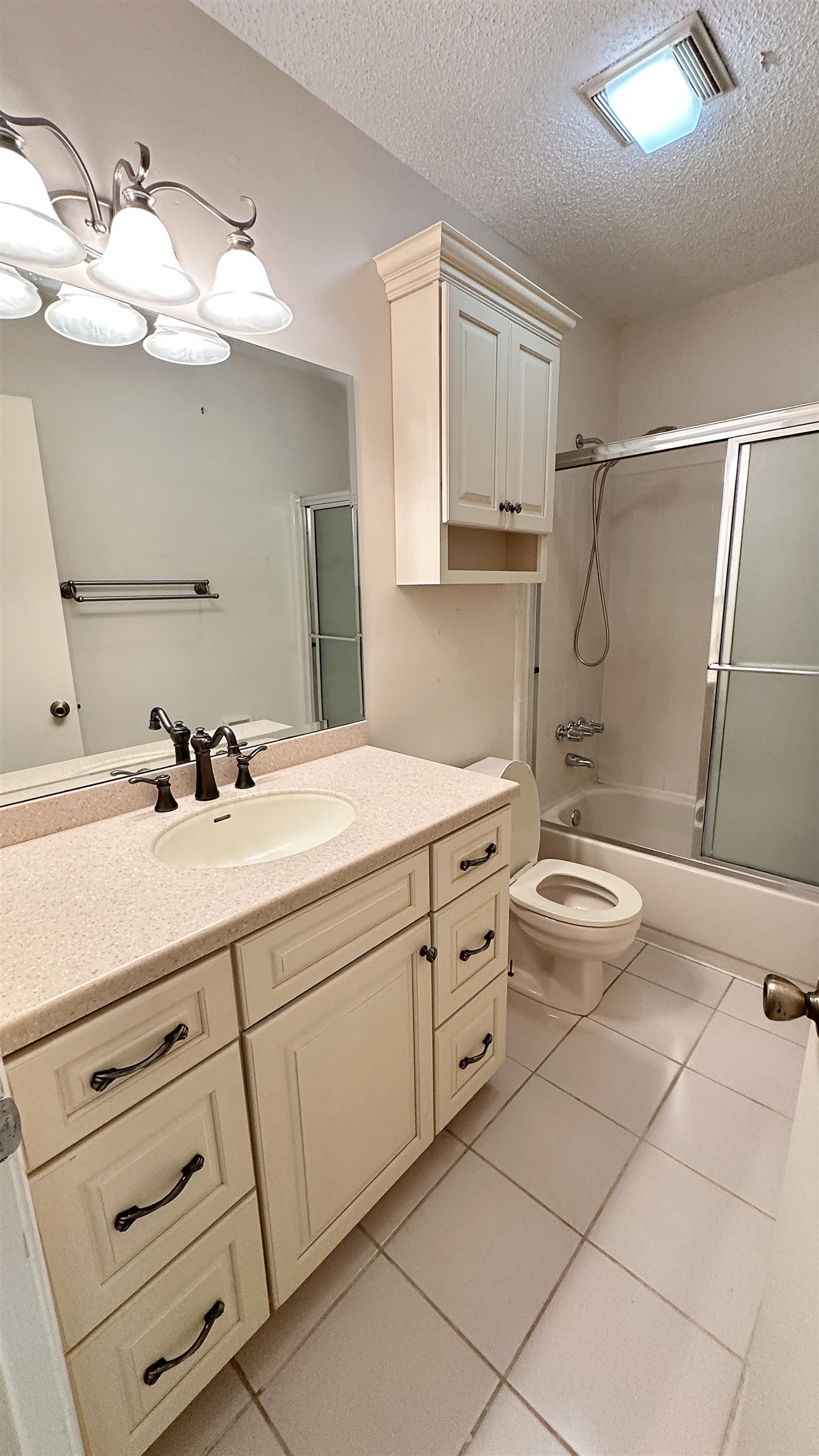 2 11th Street St. Augustine Beach, FL 32080 - Photo 69 of 72 Full bathroom with vanity, enclosed tub / shower combo, a textured ceiling, and light tile patterned floors