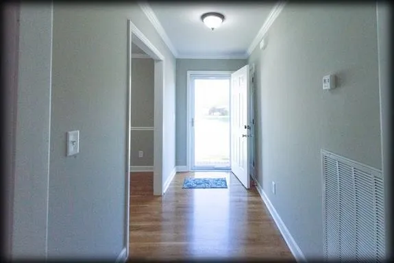 a view of gallery with wooden floor