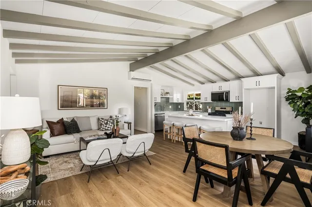 a living room with lots of furniture and kitchen view