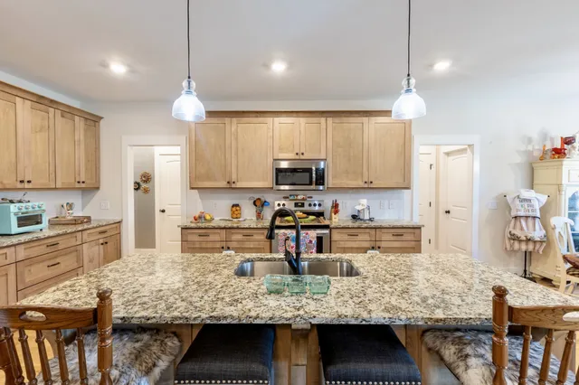 a bedroom with a bed and a large mirror on the dresser