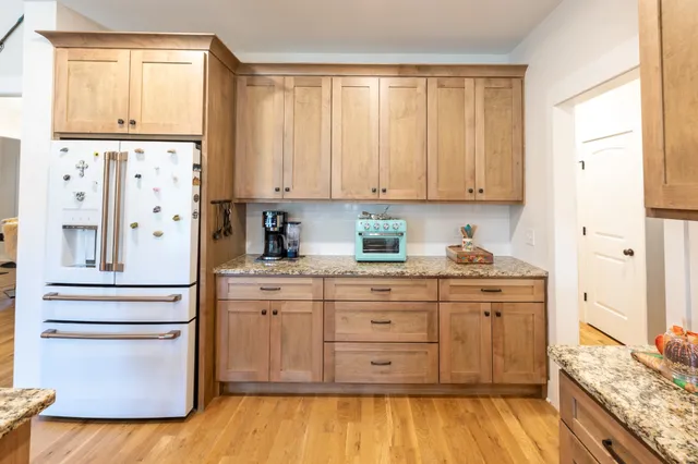 a spacious bathroom with a granite countertop tub sink and mirror
