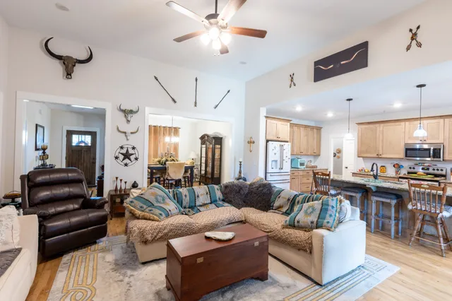 a living room with furniture and a chandelier