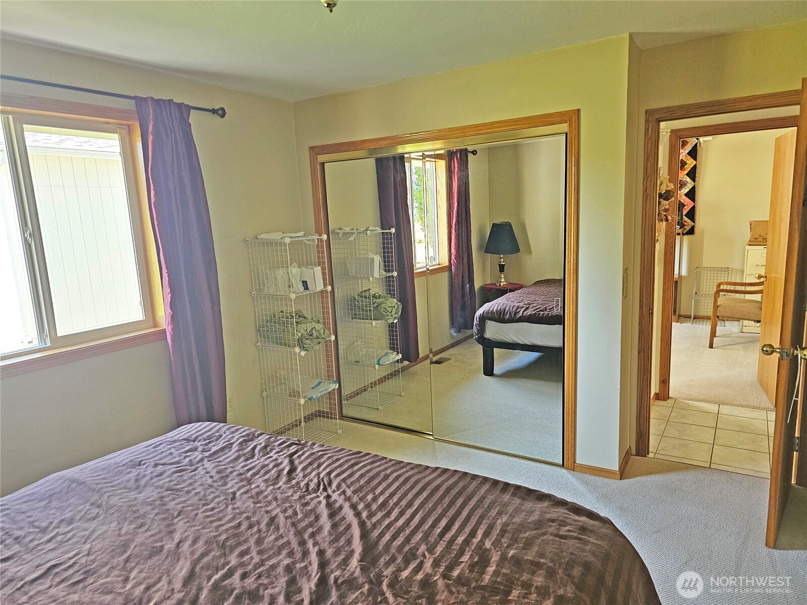 17103 Camas Run Lane Southwest Rochester, WA 98579 - Photo 19 of 40 a bedroom with a bed and glass door