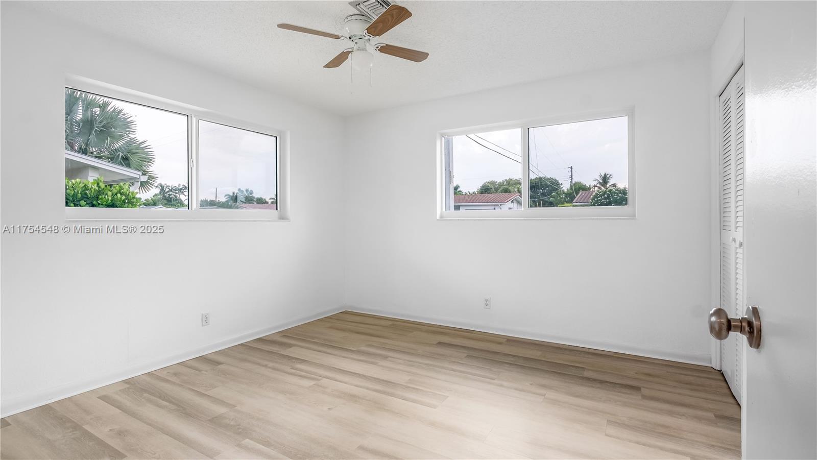 28 Southwest 9th Avenue Boca Raton, FL 33486 - Photo 22 of 27 a view of a big room with wooden floor closet and windows