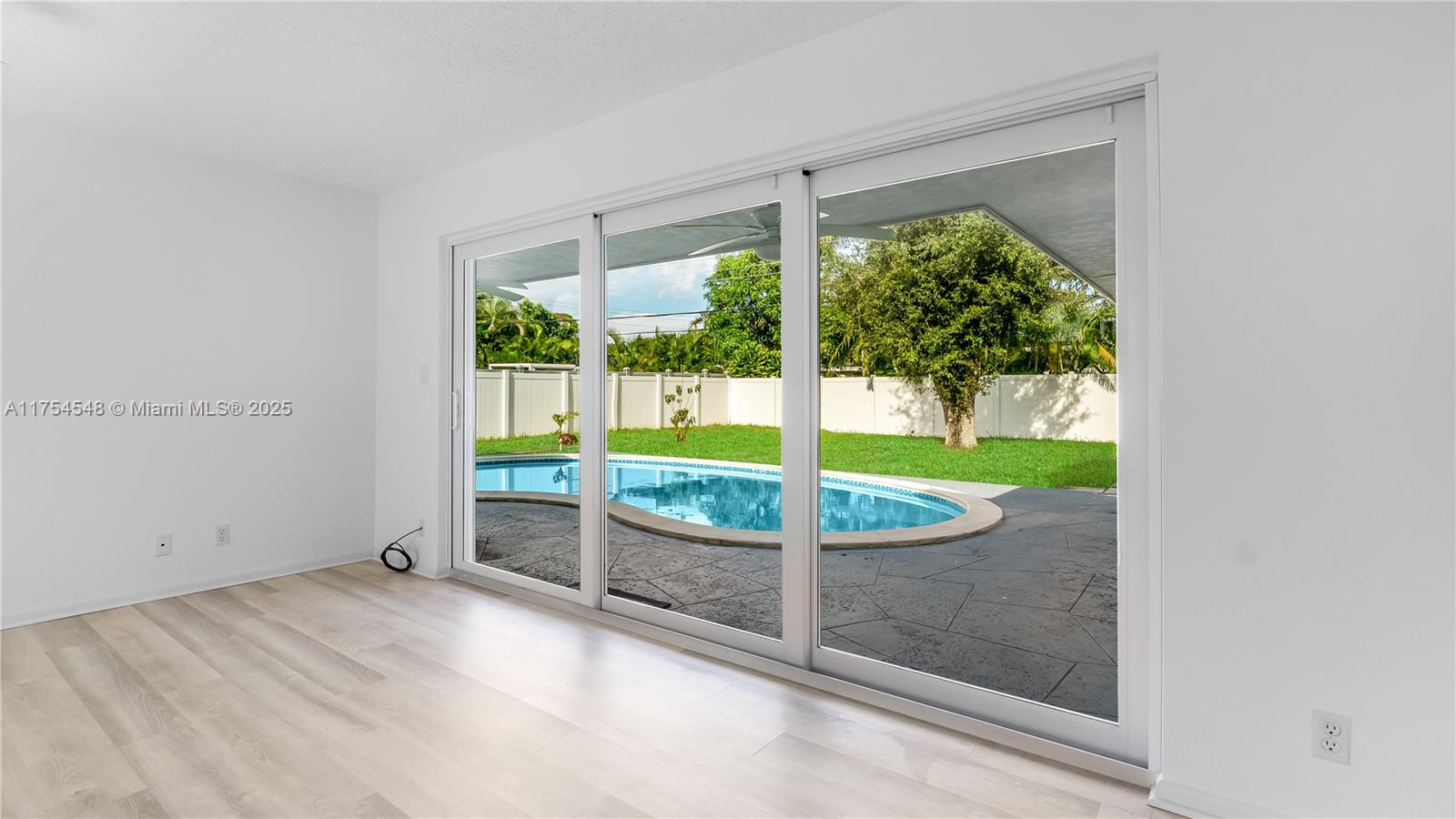 28 Southwest 9th Avenue Boca Raton, FL 33486 - Photo 8 of 27 an empty room with floor to ceiling windows and outdoor view