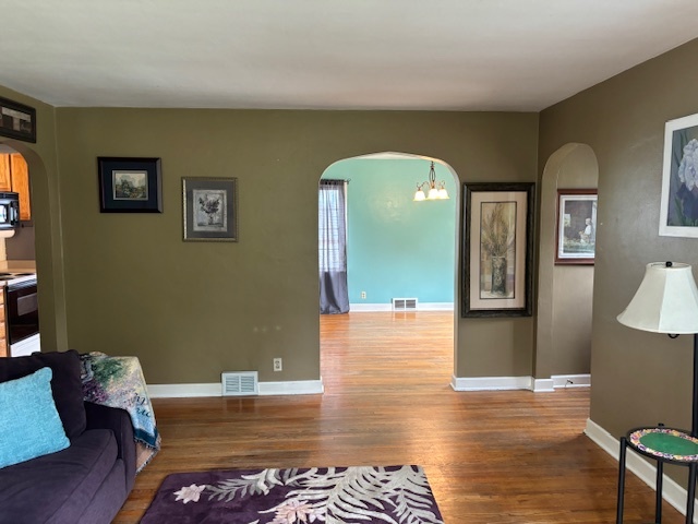 704 Woolf Court Rochelle, IL 61068 - Photo 8 of 40 a living room with furniture and a wooden floor