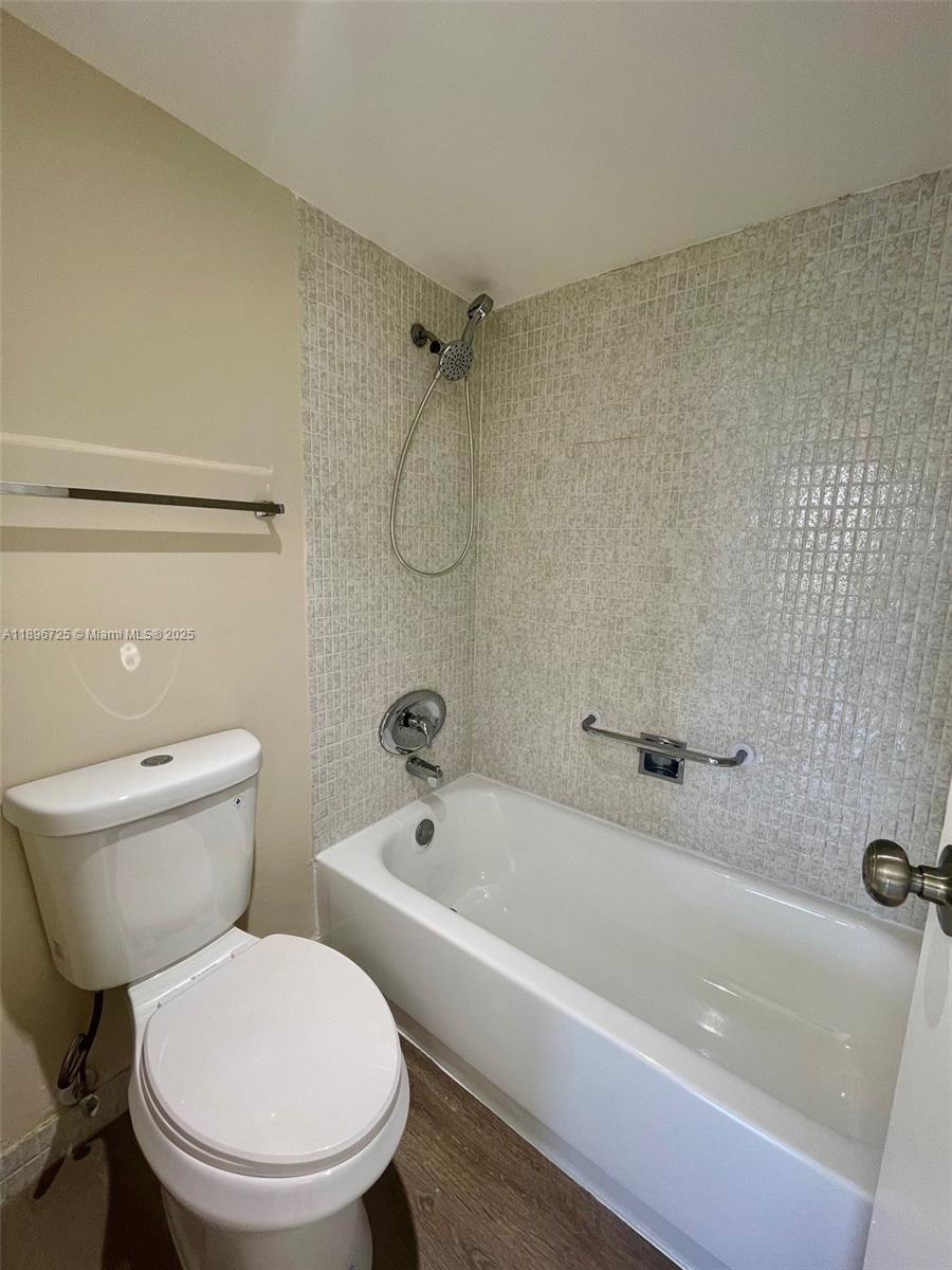 20400 West Country Club Drive, Unit 608 Aventura, FL 33180 - Photo 11 of 19 a white toilet and tub sitting next to a bathroom sink