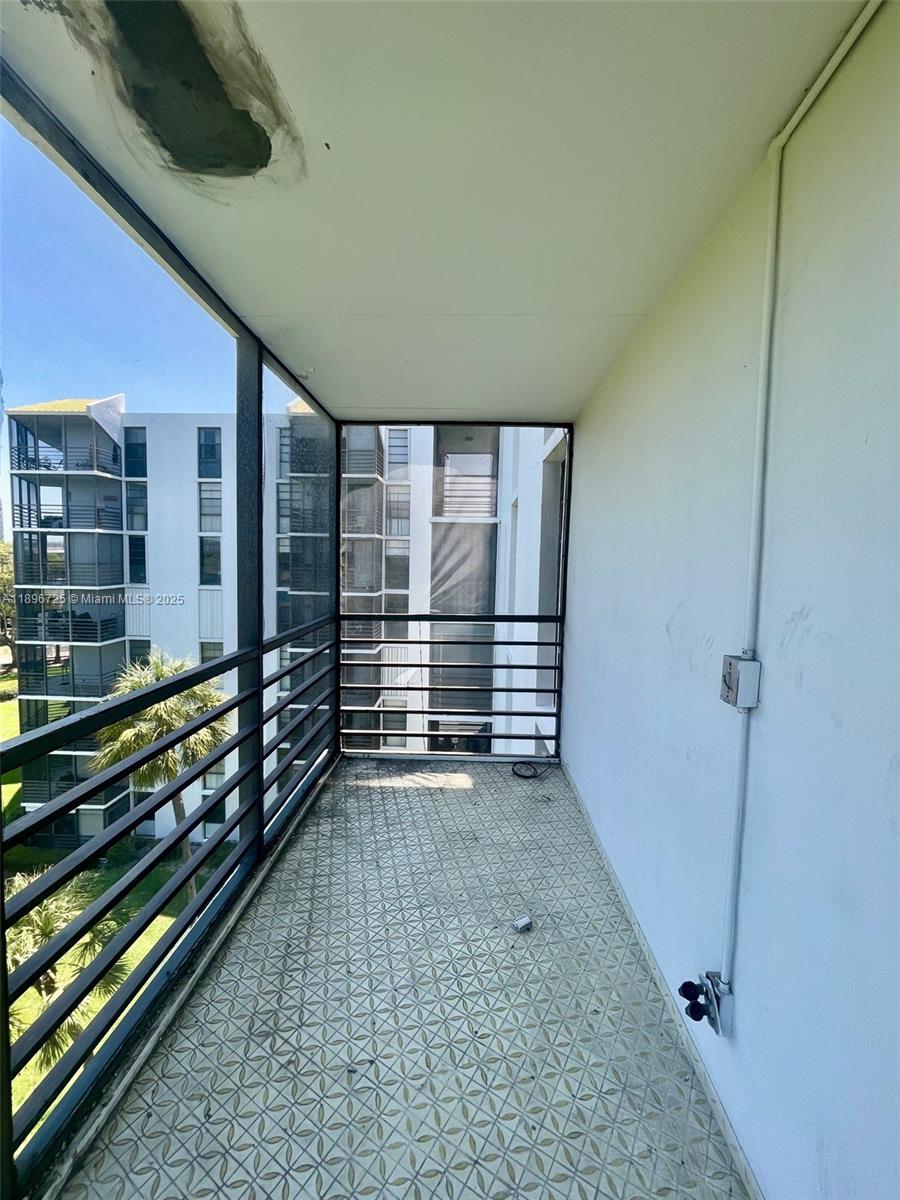 20400 West Country Club Drive, Unit 608 Aventura, FL 33180 - Photo 16 of 19 a view of a porch with wooden floor and fence
