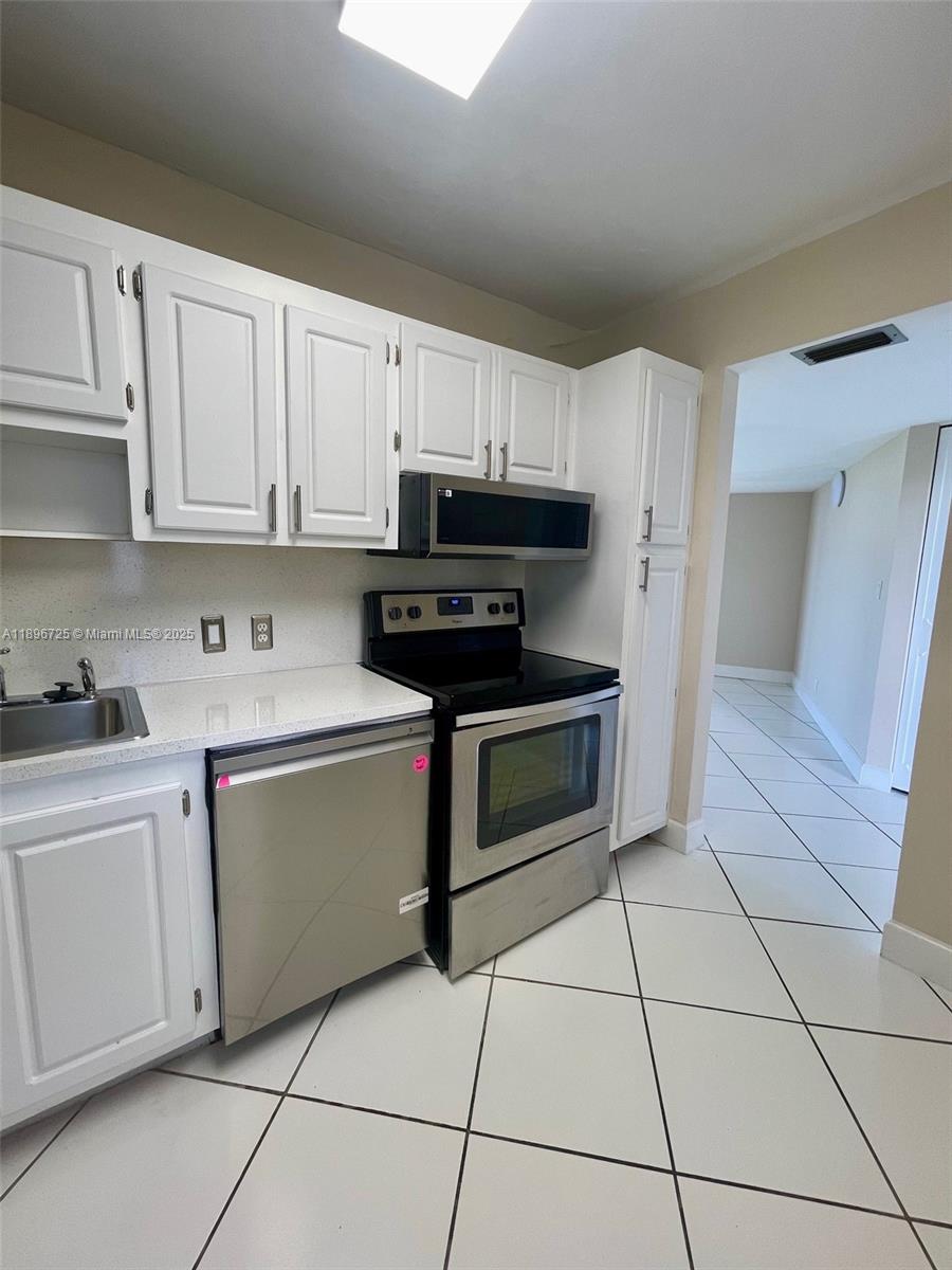 20400 West Country Club Drive, Unit 608 Aventura, FL 33180 - Photo 7 of 19 a kitchen with cabinets and appliances
