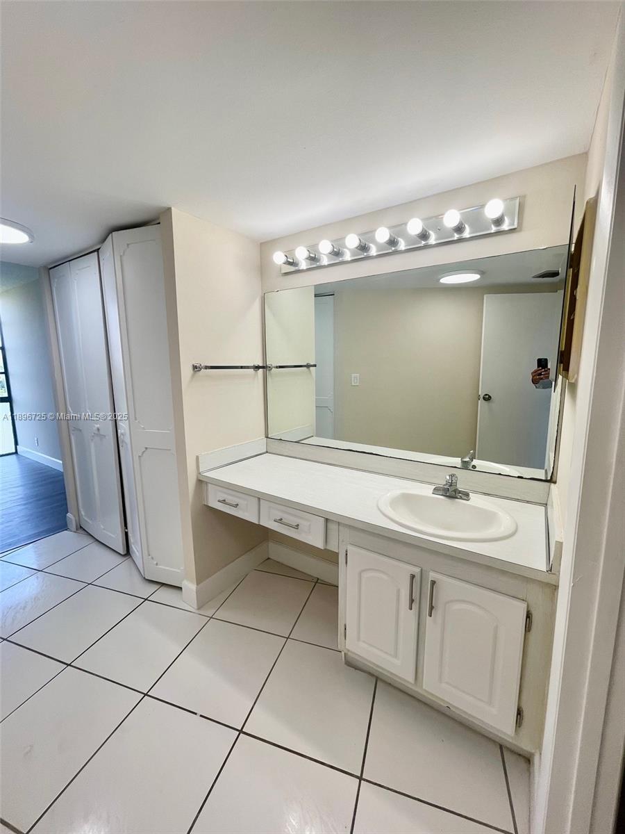 20400 West Country Club Drive, Unit 608 Aventura, FL 33180 - Photo 8 of 19 a bathroom with a sink and a mirror
