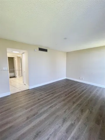 a white toilet and tub sitting next to a bathroom sink