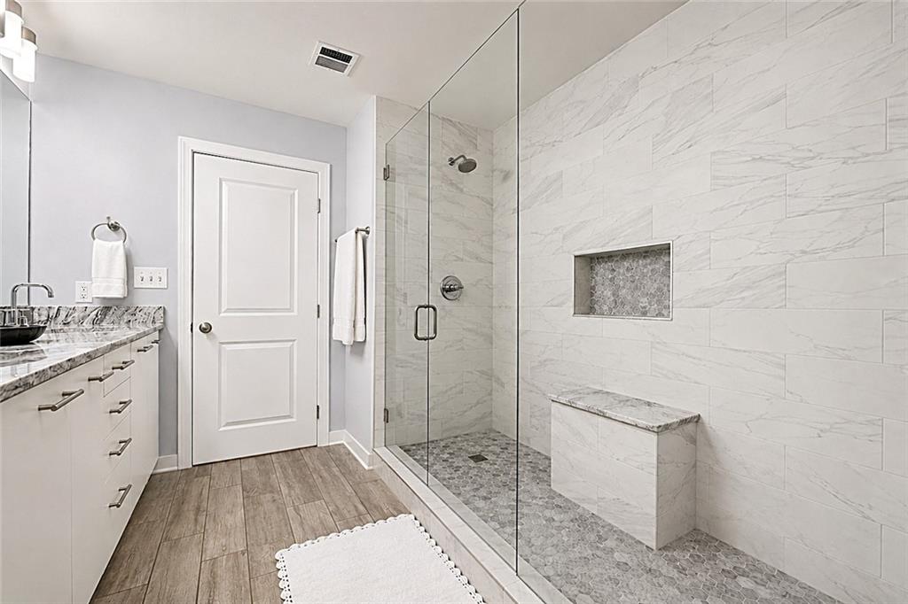 3300 Windy Ridge Parkway Southeast, Unit 1112 Atlanta, GA 30339 - Photo 15 of 43 a bathroom with a sink a toilet and shower
