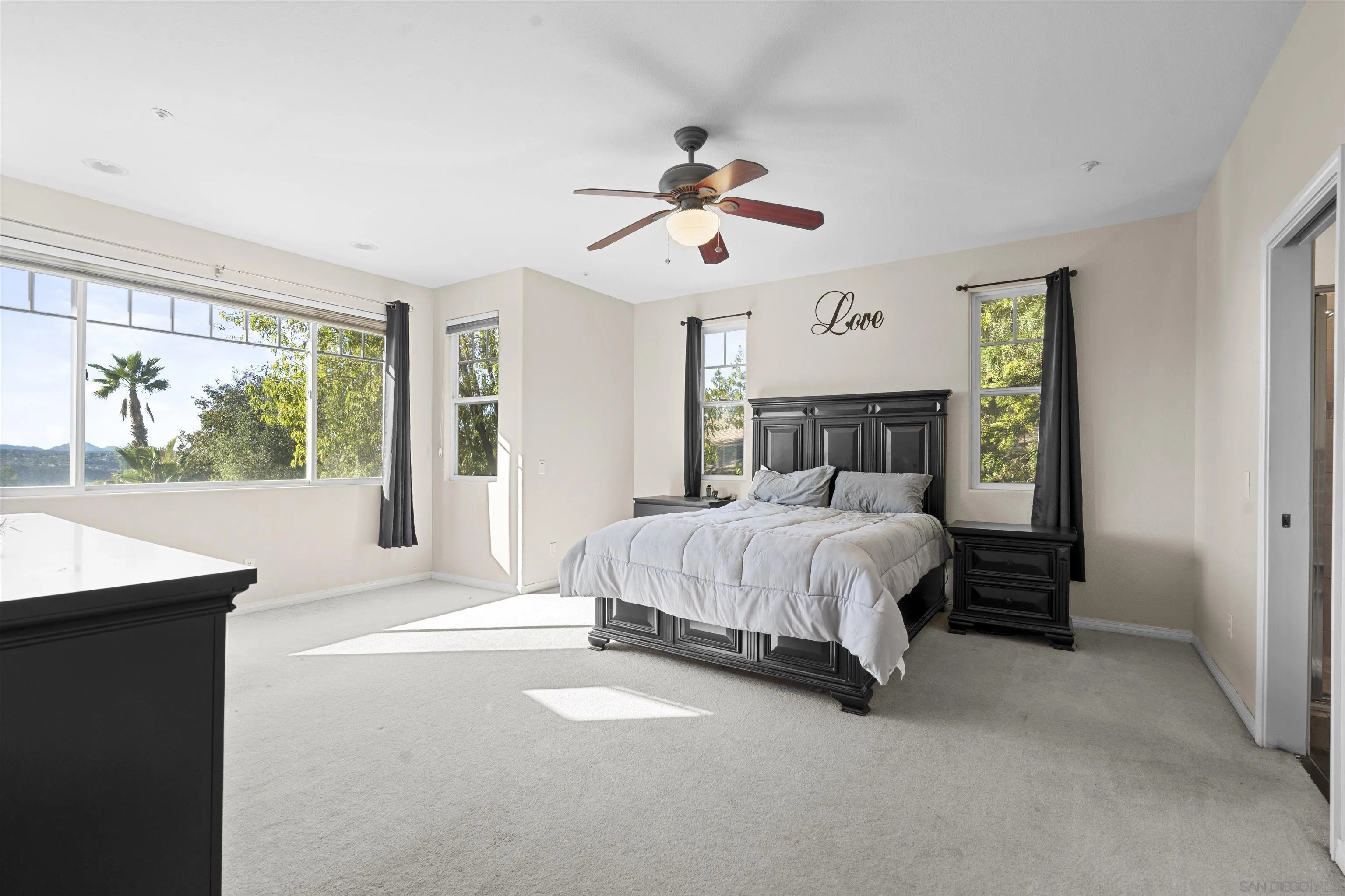 24534 Rutherford Road Ramona, CA 92065 - Photo 11 of 19 a bed sitting in a spacious bedroom next to a window