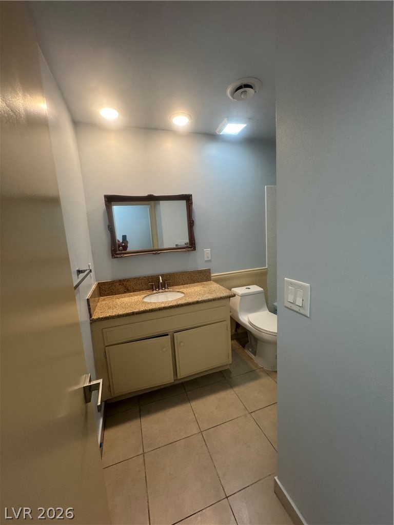4420 Del Monte Avenue, Unit RENTAL Las Vegas, NV 89102 - Photo 14 of 20 A well-appointed bathroom features a practical vanity with a granite countertop and tiled flooring.