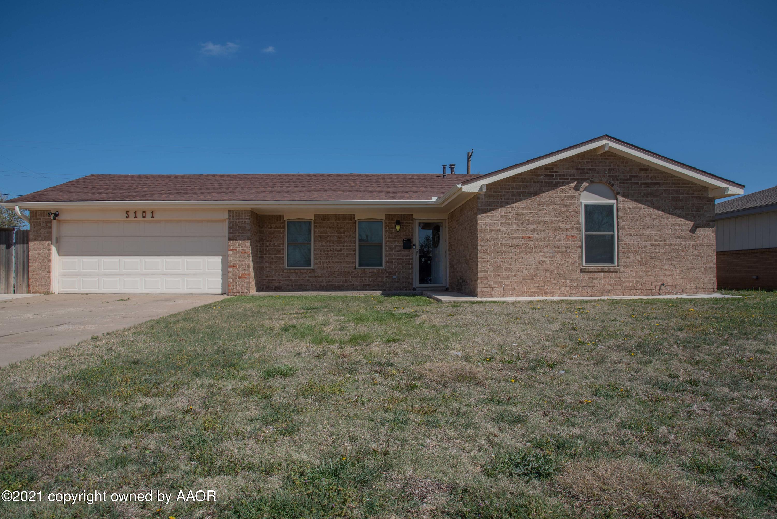 5101 South Austin Street Amarillo, TX 79110 - Photo 1 of 24 a front view of a house with a garden