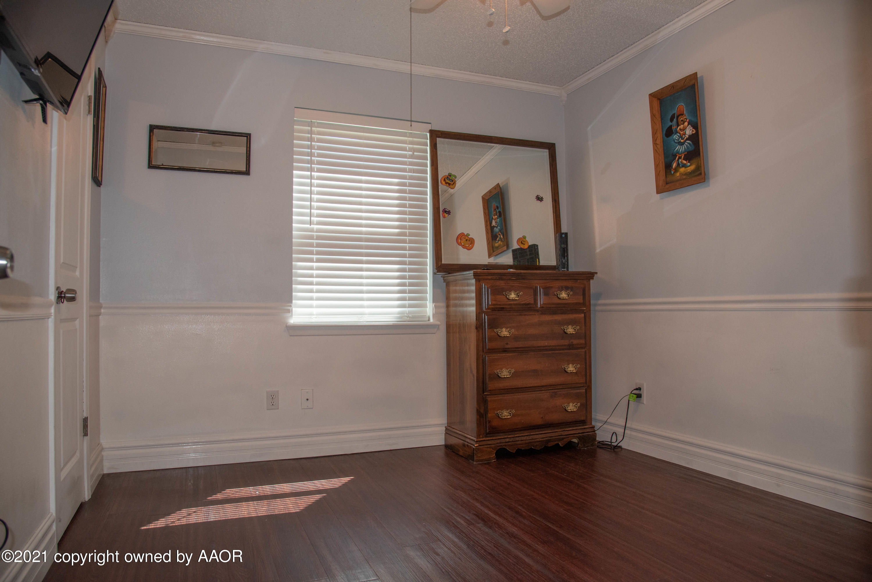 5101 South Austin Street Amarillo, TX 79110 - Photo 14 of 24 an empty room with wooden floor closet and windows