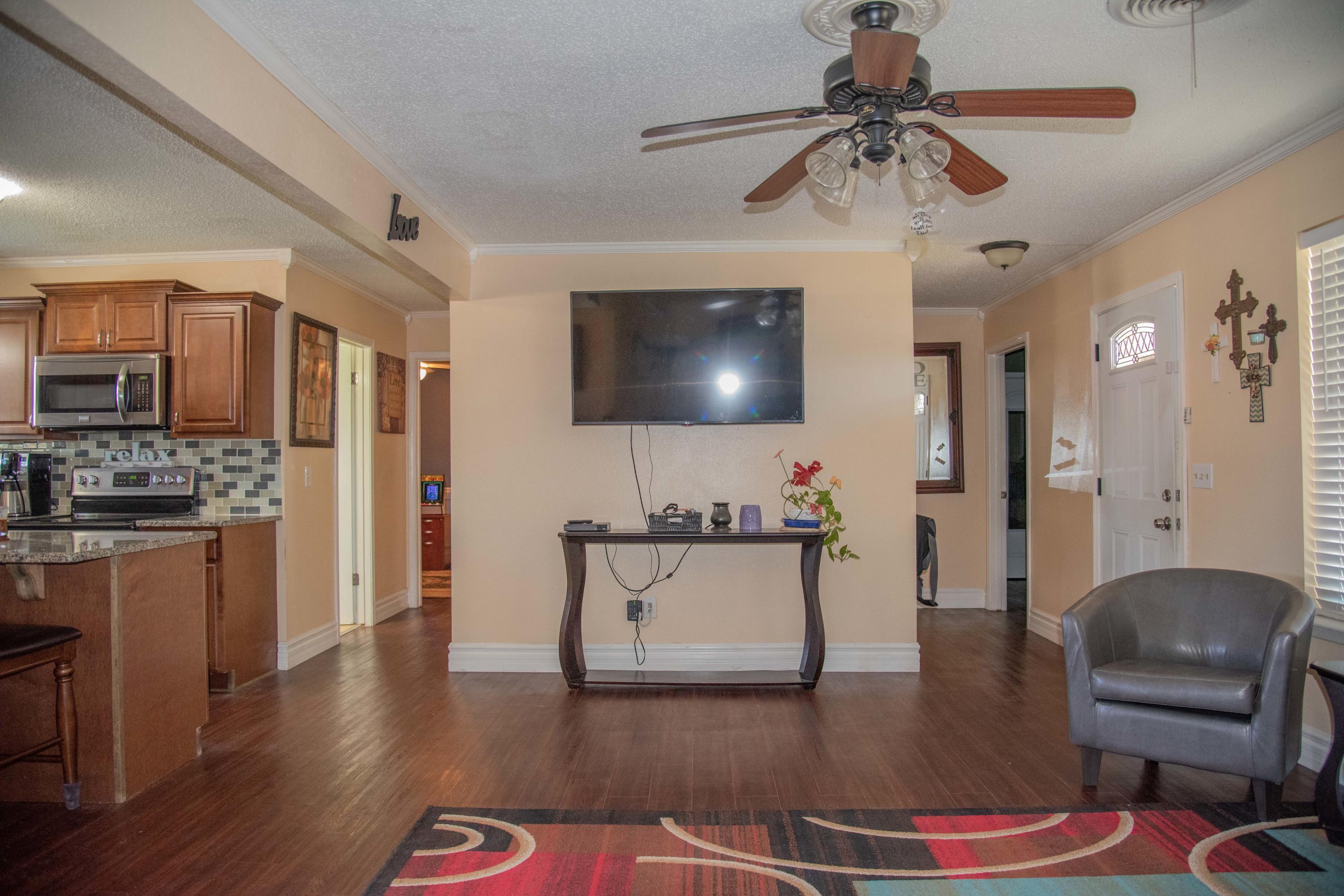 5101 South Austin Street Amarillo, TX 79110 - Photo 5 of 24 a living room with furniture and a flat screen tv