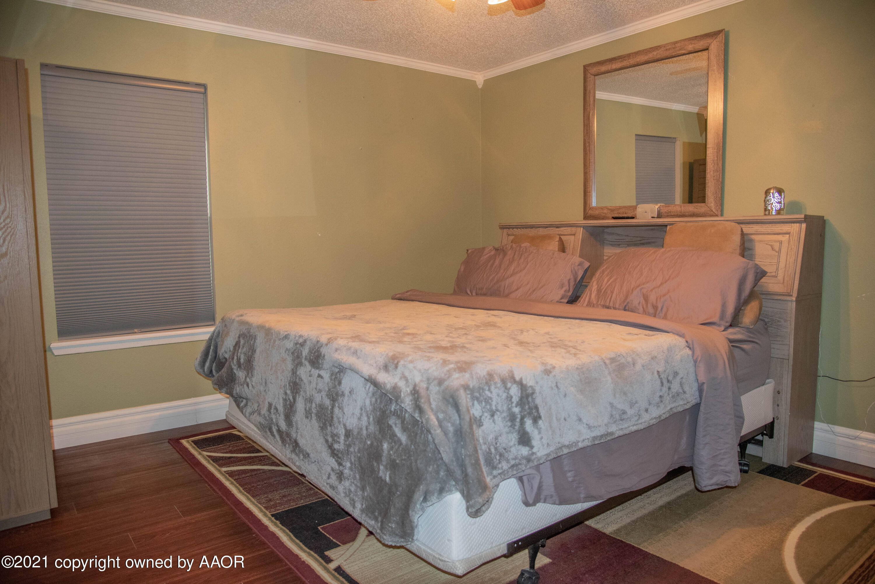 5101 South Austin Street Amarillo, TX 79110 - Photo 10 of 24 a bedroom with a bed and wooden floor