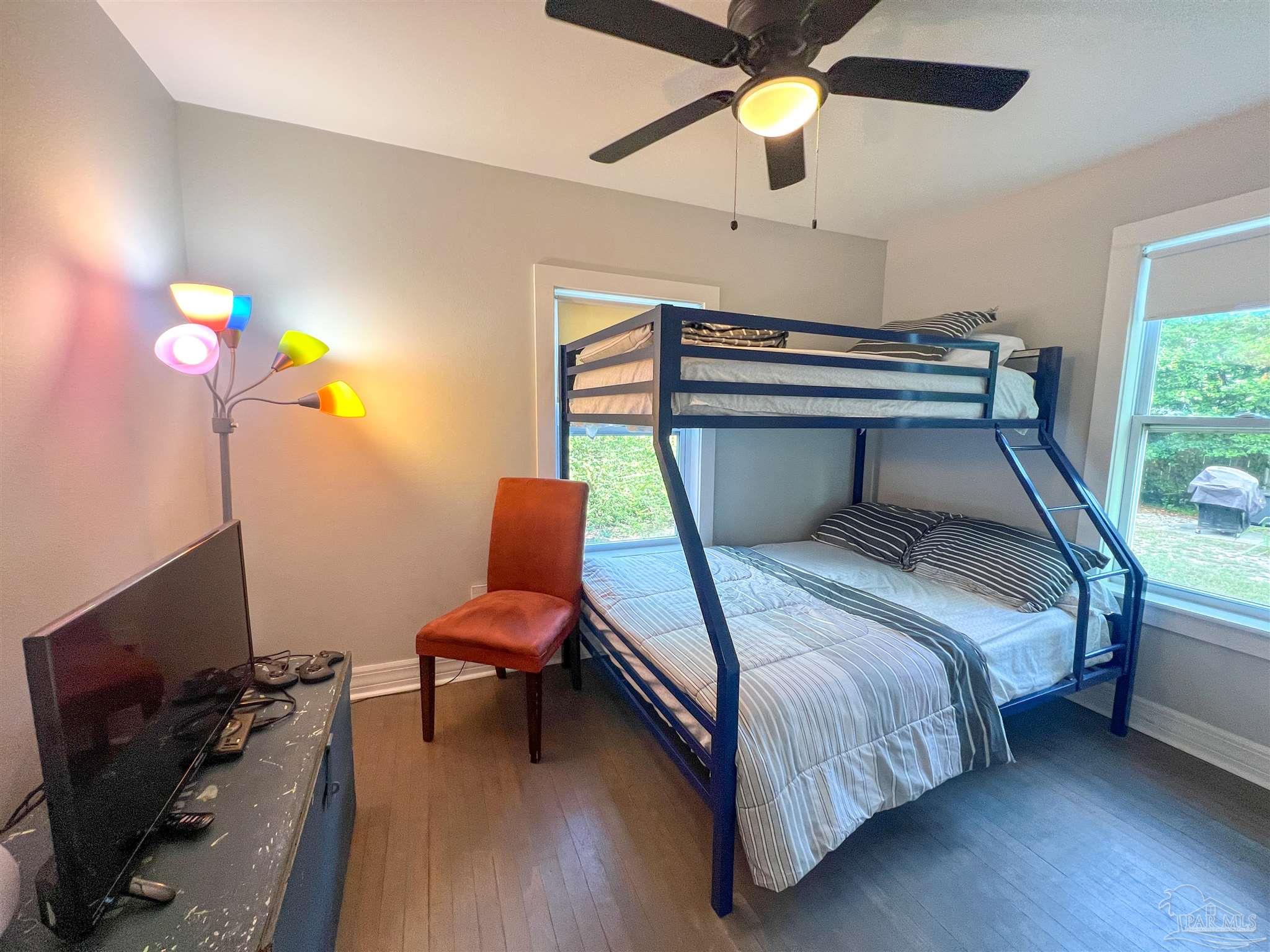 1315 Dexter Avenue Pensacola, FL 32507 - Photo 13 of 22 a bedroom with a bed and a chandelier