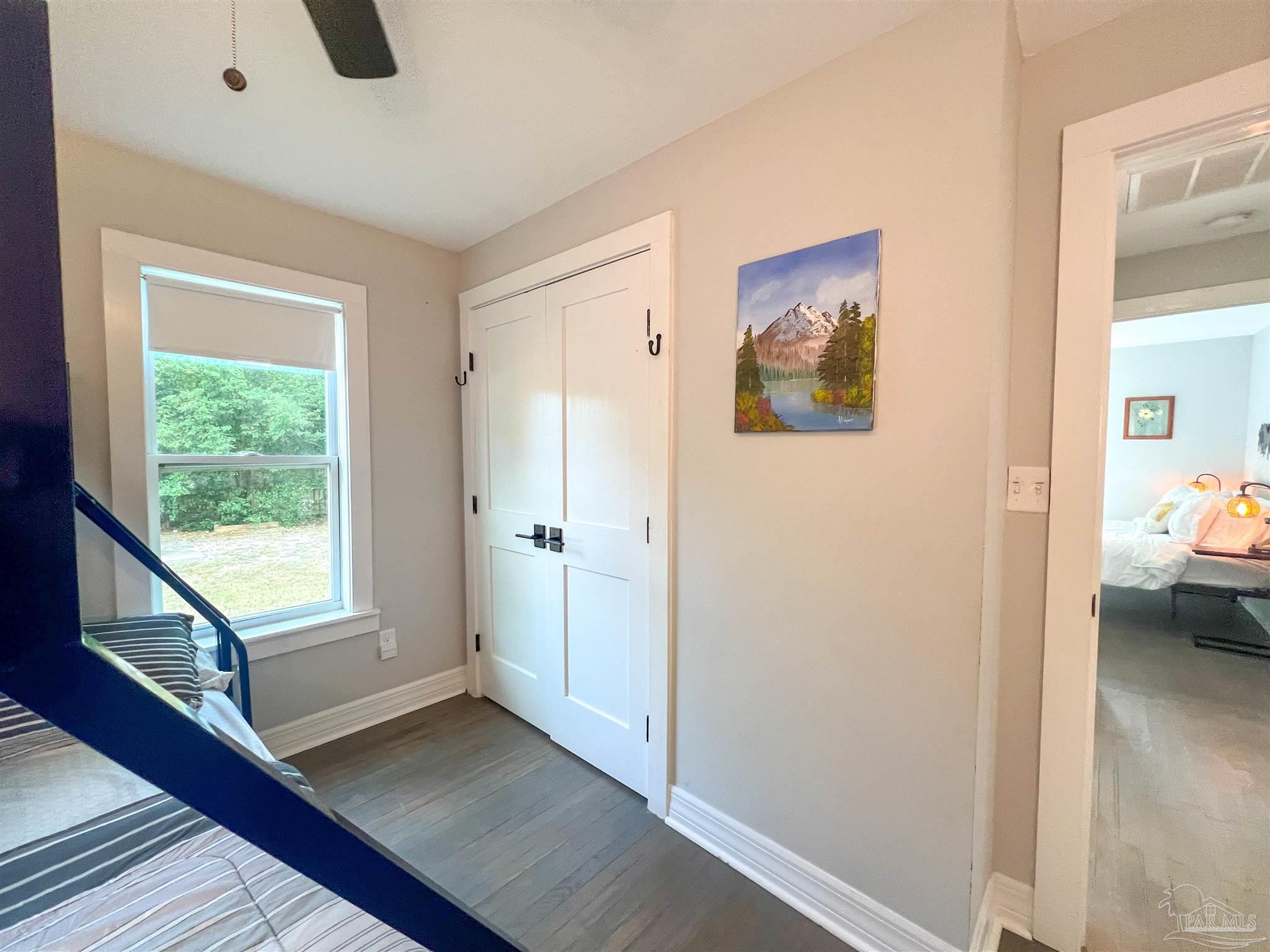 1315 Dexter Avenue Pensacola, FL 32507 - Photo 14 of 22 a view of a bedroom with wooden floor and windows