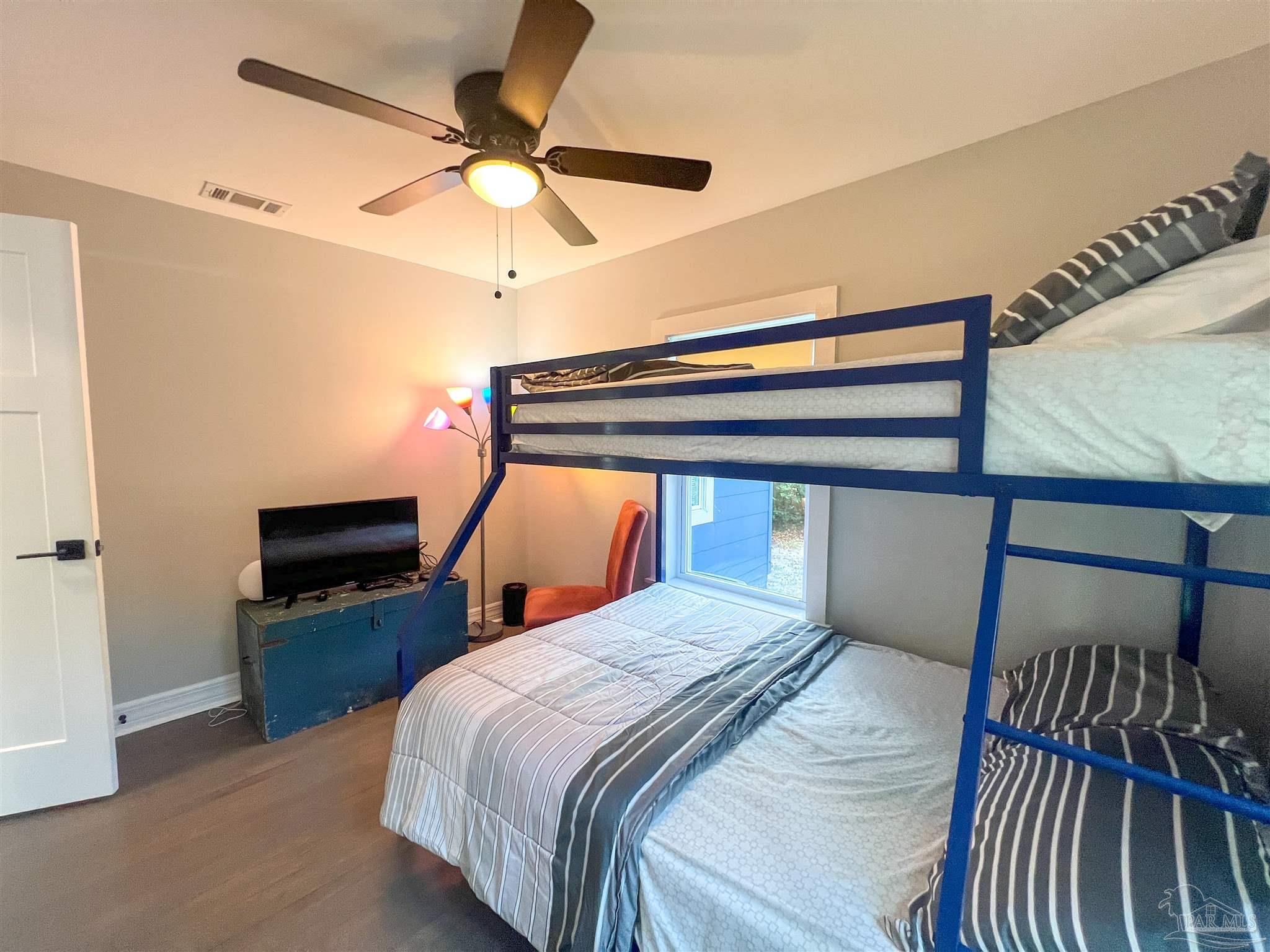 1315 Dexter Avenue Pensacola, FL 32507 - Photo 15 of 22 a bedroom with a bed and a chandelier