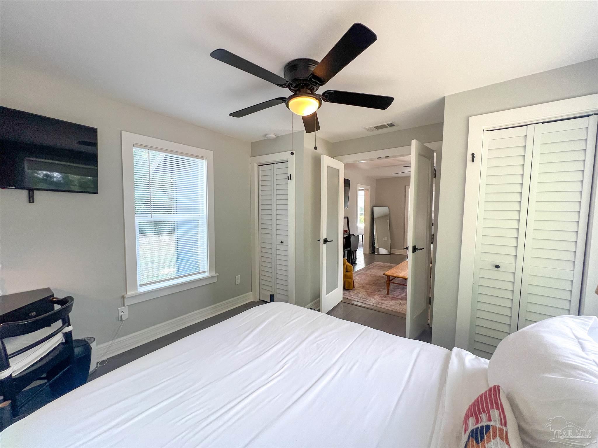 1315 Dexter Avenue Pensacola, FL 32507 - Photo 22 of 22 a bedroom with a bed and a chandelier