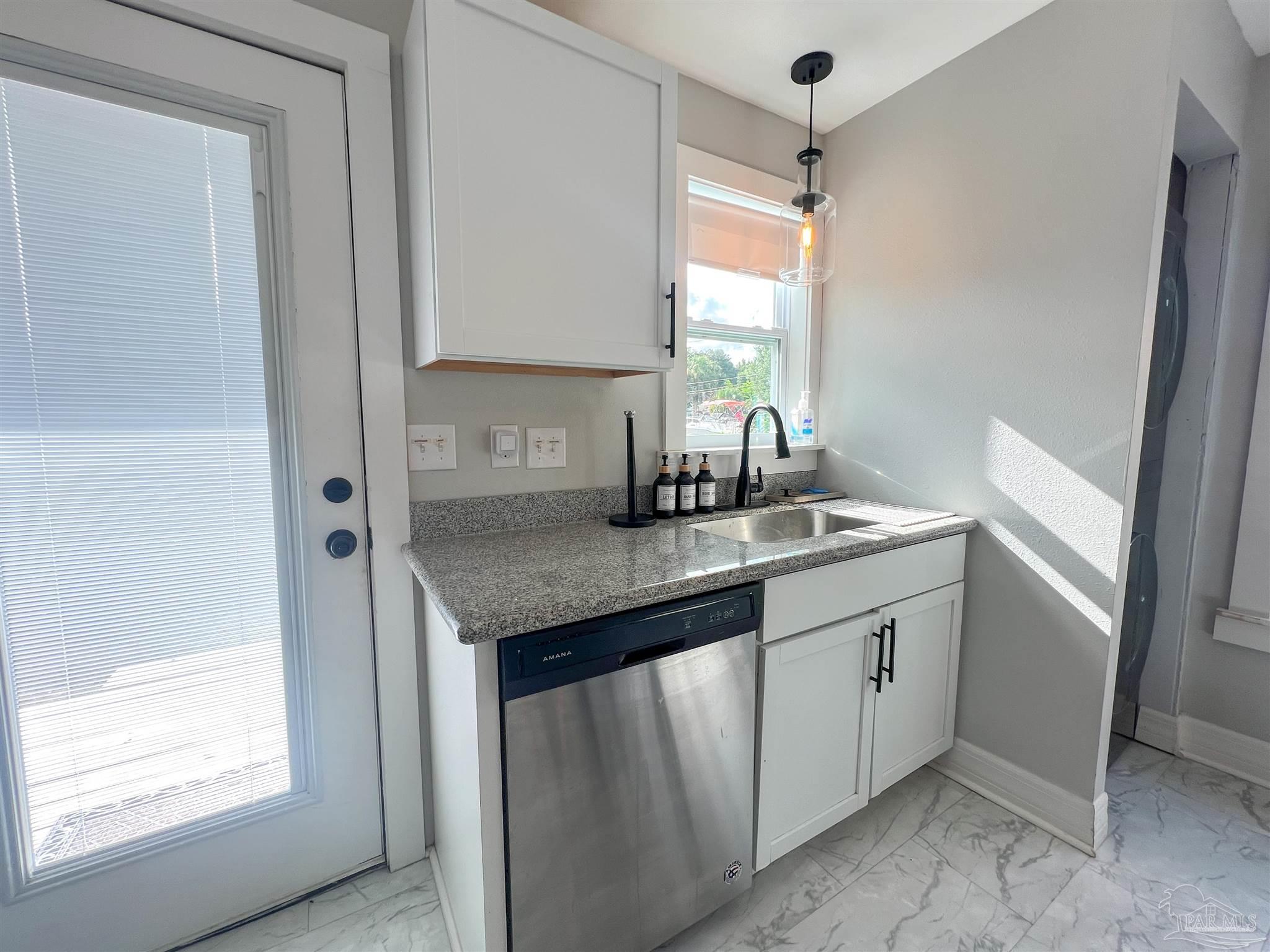 1315 Dexter Avenue Pensacola, FL 32507 - Photo 7 of 22 a kitchen with stainless steel appliances granite countertop a sink and a window