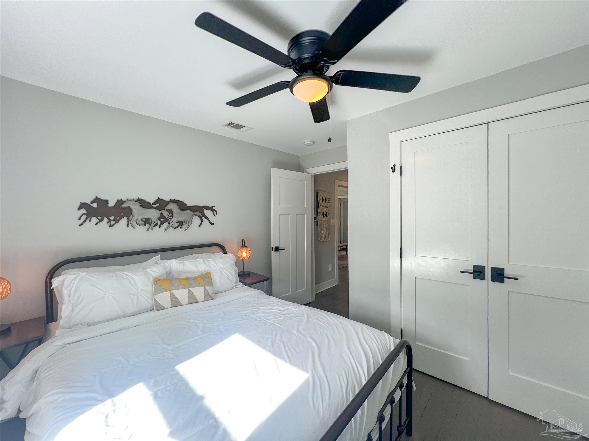 1315 Dexter Avenue Pensacola, FL 32507 - Photo 10 of 22 a bedroom with a bed and a ceiling fan