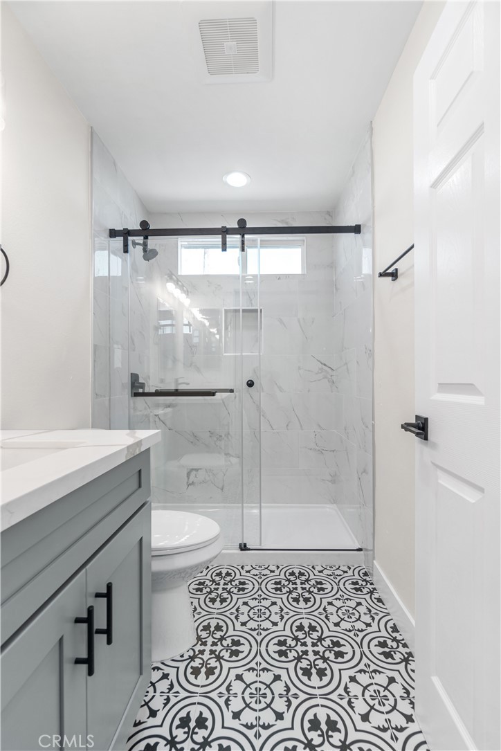 523 West 12th Street, Unit 2 San Pedro, CA 90731 - Photo 15 of 17 a bathroom with a granite countertop sink toilet and shower