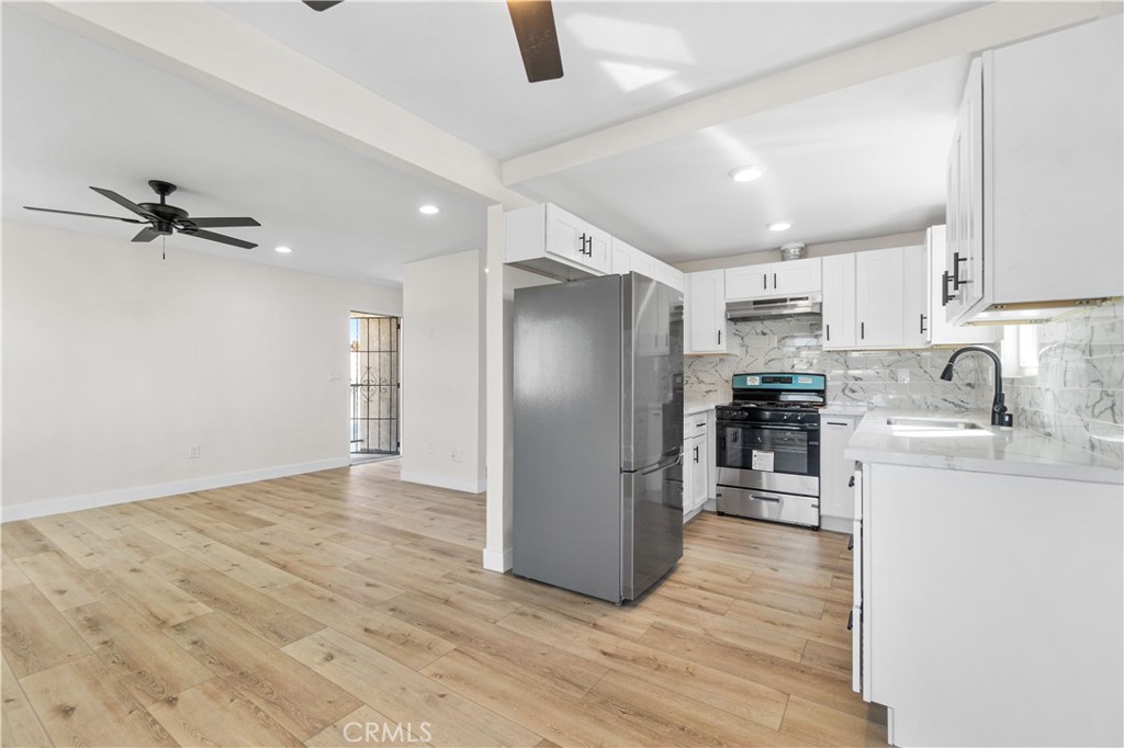 523 West 12th Street, Unit 2 San Pedro, CA 90731 - Photo 8 of 17 a kitchen with stainless steel appliances a refrigerator and a sink