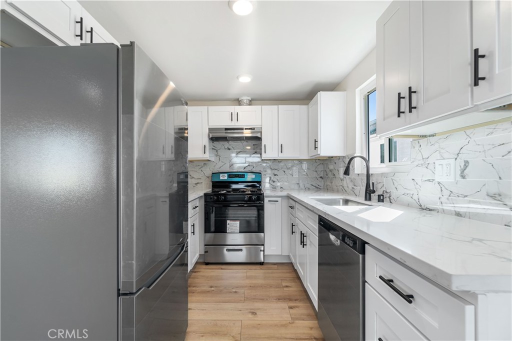 523 West 12th Street, Unit 2 San Pedro, CA 90731 - Photo 9 of 17 a kitchen with stainless steel appliances granite countertop a sink stove and refrigerator
