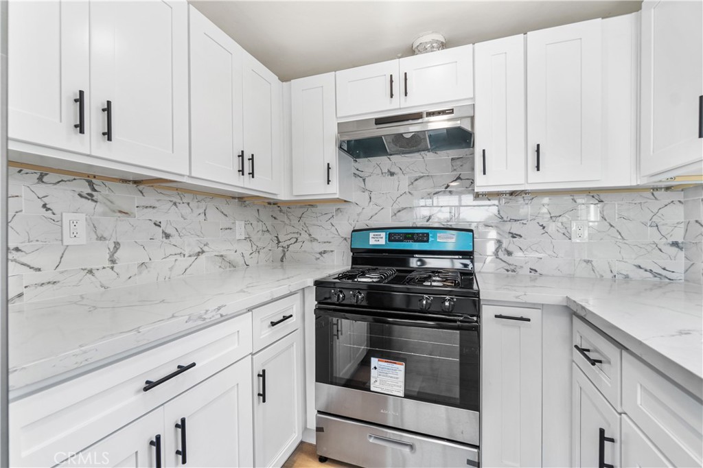 523 West 12th Street, Unit 2 San Pedro, CA 90731 - Photo 10 of 17 a kitchen with white cabinets and appliances