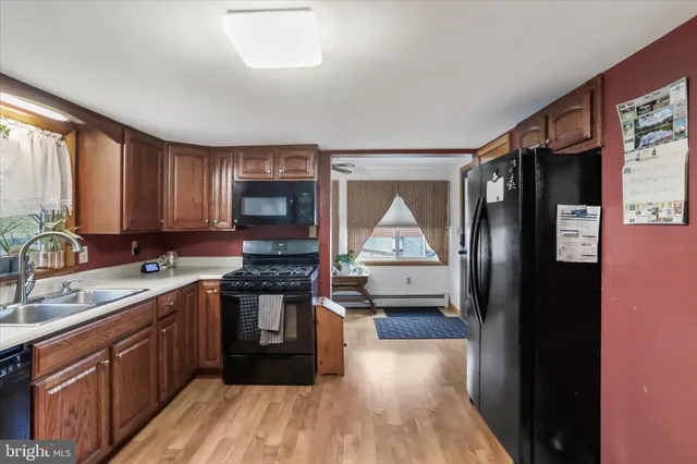 a kitchen with a sink stove and refrigerator