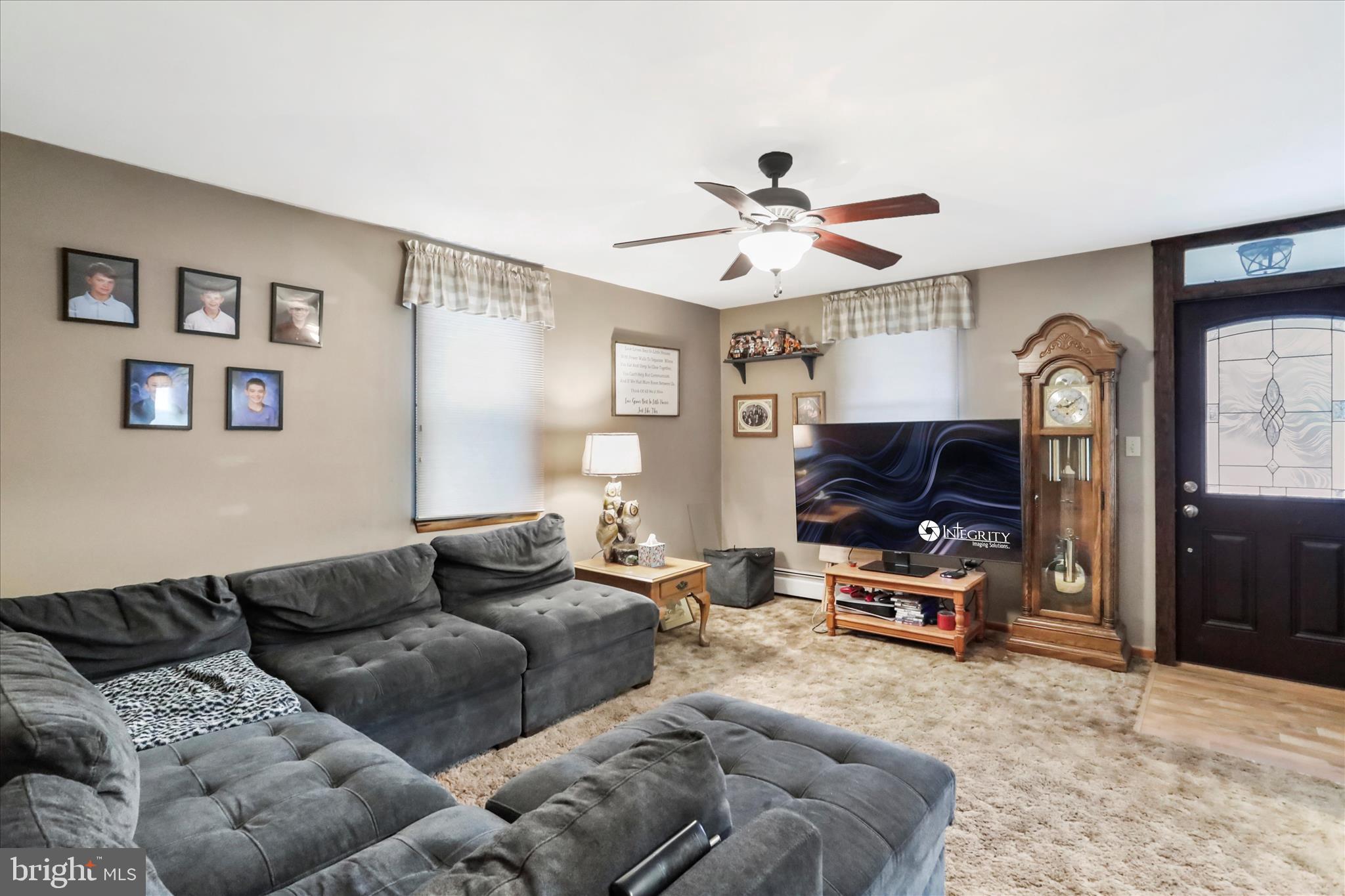 17211 Porter Road Southwest Frostburg, MD 21532 - Photo 13 of 34 a living room with furniture a ceiling fan and a window