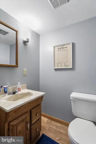 a bathroom with a sink a toilet and mirror