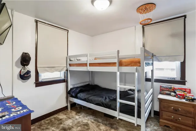 a bedroom with bunk bed and a window