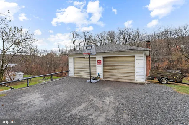 a view of a house with a yard and wooden fence
