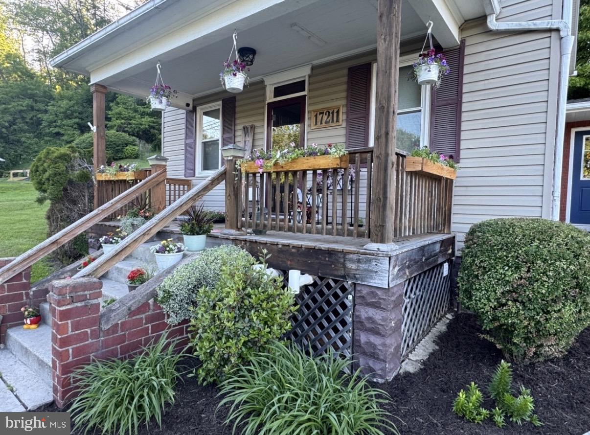 17211 Porter Road Southwest Frostburg, MD 21532 - Photo 5 of 34 a view of a house with wooden deck and furniture