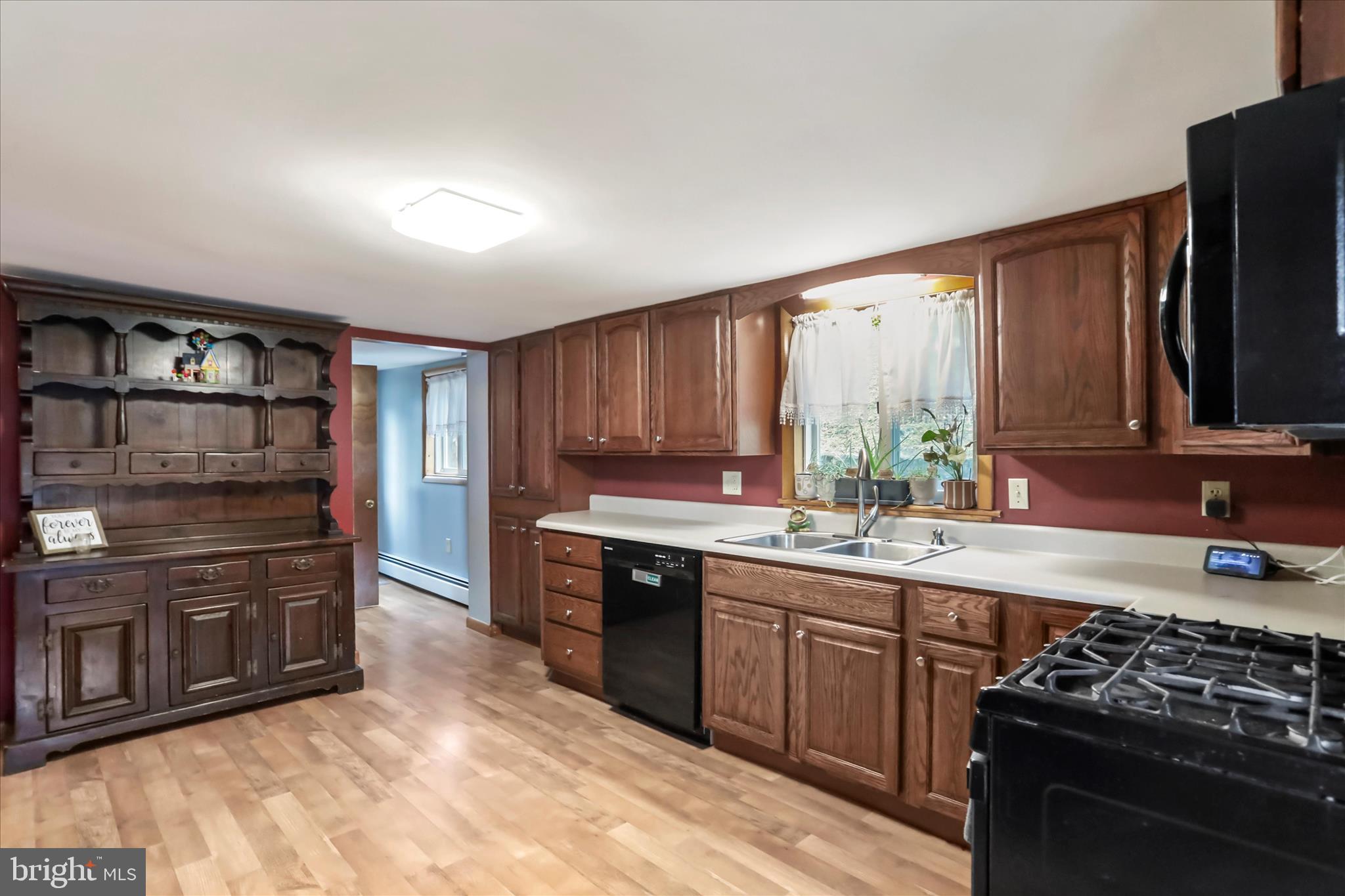 17211 Porter Road Southwest Frostburg, MD 21532 - Photo 10 of 34 a kitchen with stainless steel appliances granite countertop a stove a sink and a refrigerator