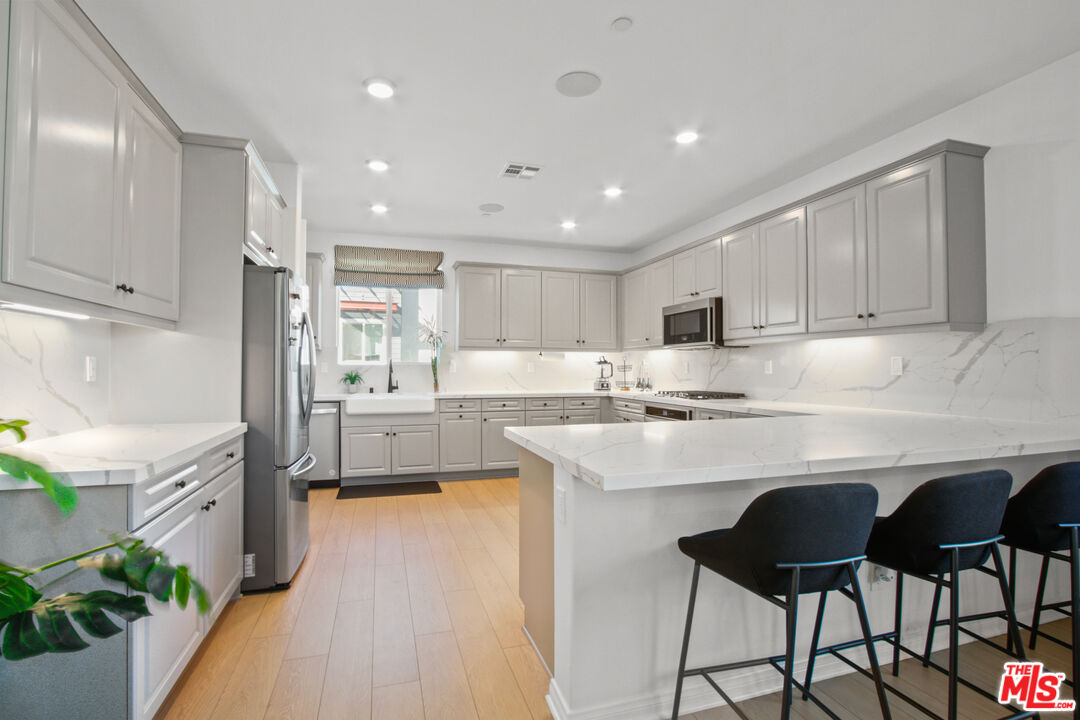 764 Daniel Freeman Circle Inglewood, CA 90301 - Photo 15 of 35 a kitchen with cabinets and chairs