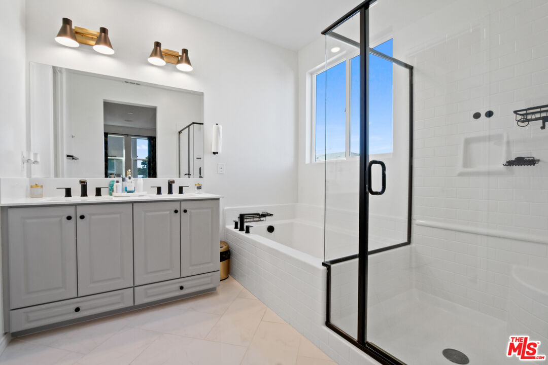 764 Daniel Freeman Circle Inglewood, CA 90301 - Photo 32 of 35 a bathroom with a double vanity sink mirror and bathtub