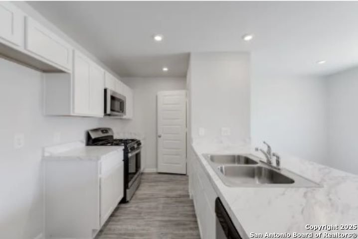617 Cadena Loop Kenedy, TX 78119 - Photo 14 of 21 a kitchen that has a sink and a stove