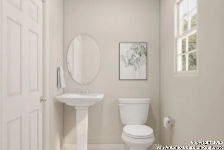 617 Cadena Loop Kenedy, TX 78119 - Photo 16 of 21 a white toilet sitting next to a bathroom sink