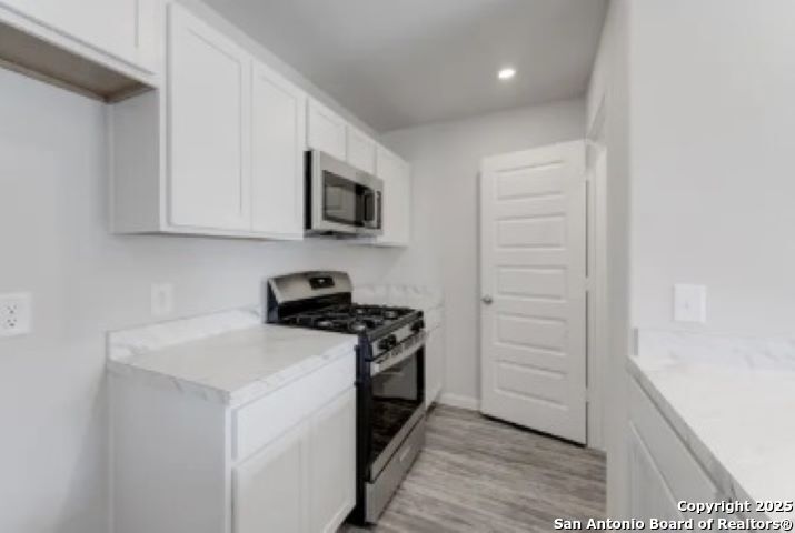 617 Cadena Loop Kenedy, TX 78119 - Photo 17 of 21 a kitchen with a sink and a stove top oven