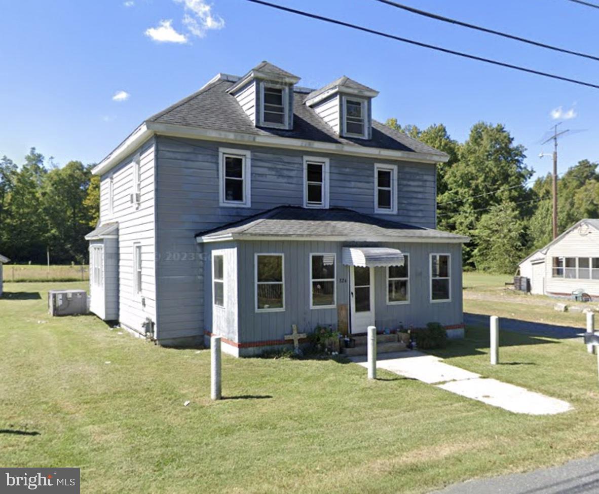a house that has a tree in front of it