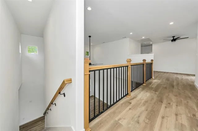 a view of a hallway with wooden floor and entryway